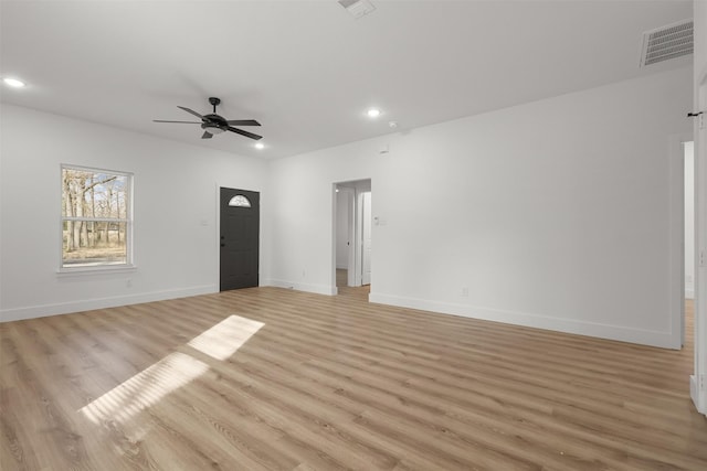 spare room with light hardwood / wood-style floors and ceiling fan