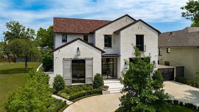 french country style house with a front yard