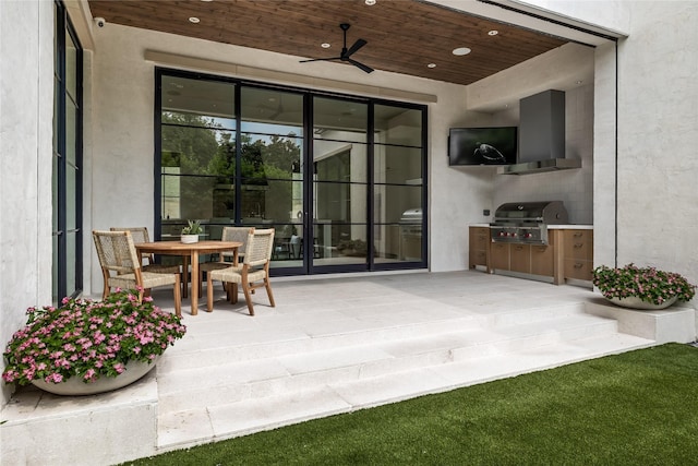 view of patio / terrace with exterior kitchen, a grill, and ceiling fan