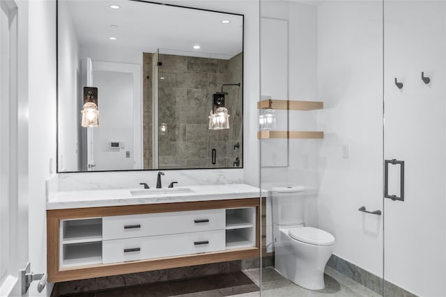 bathroom featuring an enclosed shower, vanity, and toilet