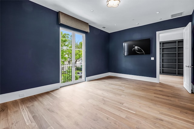 empty room with light wood-type flooring and built in features