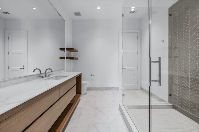 bathroom featuring vanity, toilet, and a shower with door