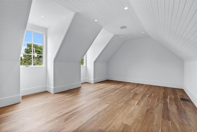 bonus room featuring lofted ceiling, wooden ceiling, and light hardwood / wood-style flooring