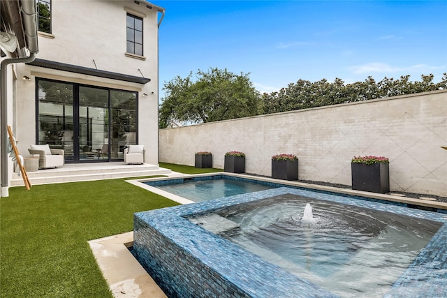 view of pool with an in ground hot tub and a lawn