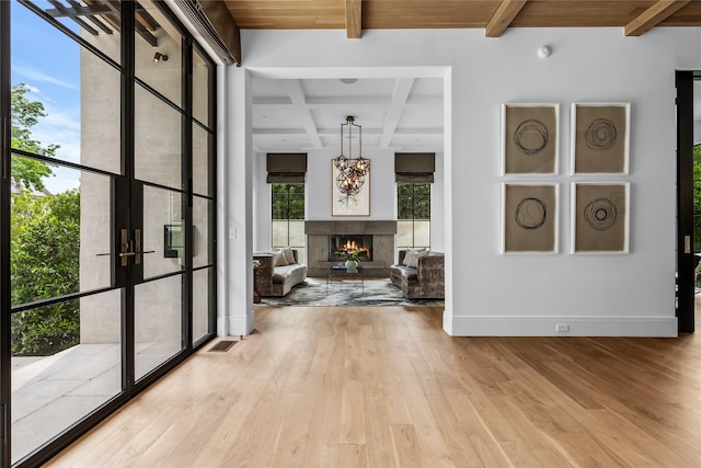 hallway featuring light hardwood / wood-style floors, wood ceiling, and beamed ceiling