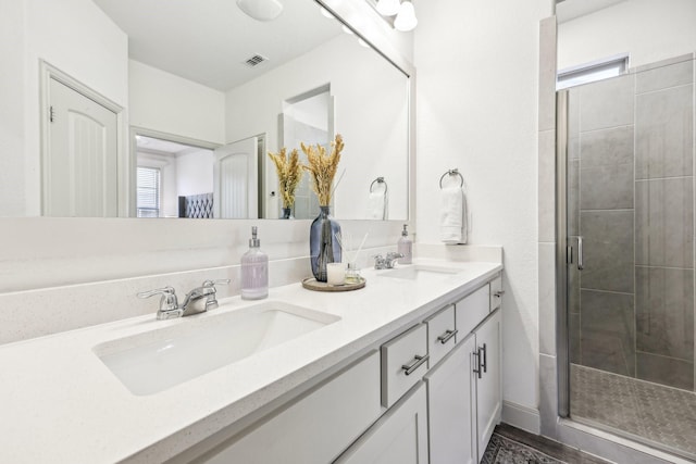 bathroom featuring an enclosed shower and vanity