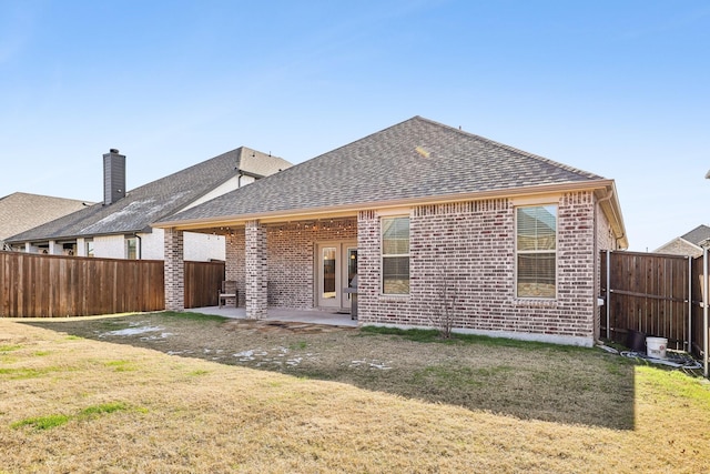 rear view of property with a patio area and a yard