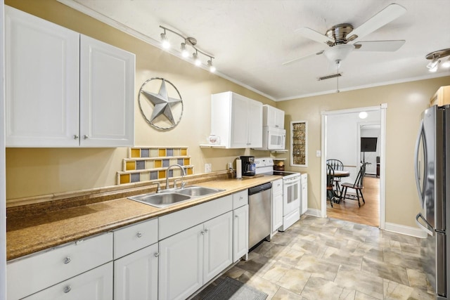 kitchen featuring sink, white cabinets, appliances with stainless steel finishes, and crown molding