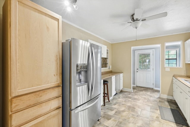 kitchen with stainless steel fridge with ice dispenser, ceiling fan, and light brown cabinets