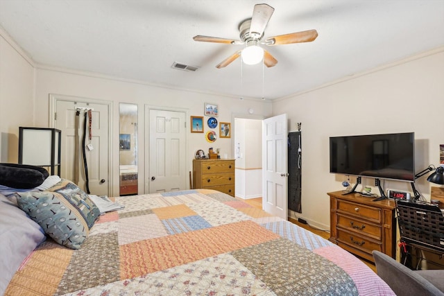 bedroom with ceiling fan, ornamental molding, connected bathroom, and hardwood / wood-style flooring