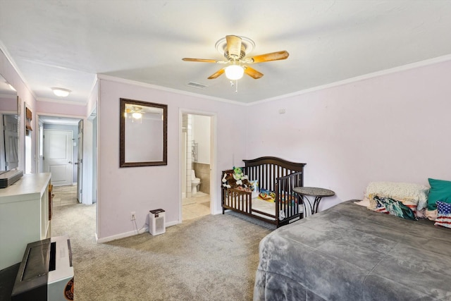 carpeted bedroom with ceiling fan, ensuite bathroom, and ornamental molding