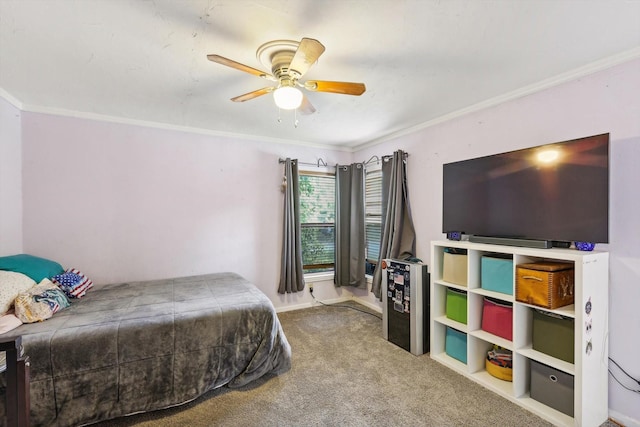 bedroom featuring ceiling fan, ornamental molding, and carpet floors