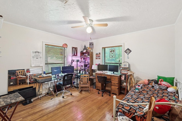 home office with a textured ceiling, ceiling fan, ornamental molding, and hardwood / wood-style flooring