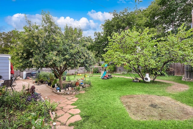 view of yard with a playground and a patio area