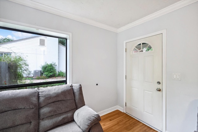 entryway featuring crown molding and hardwood / wood-style floors