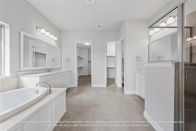 full bathroom with a garden tub, vanity, visible vents, a spacious closet, and a stall shower