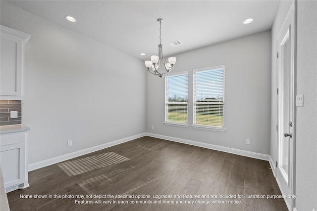 unfurnished dining area featuring dark wood-type flooring, recessed lighting, a chandelier, and baseboards