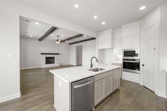 3270 Arbor Grove Trl, Midlothian, TX 76065 - kitchen with appliances with stainless steel finishes, ceiling fan, a sink, beam ceiling, and white cabinets