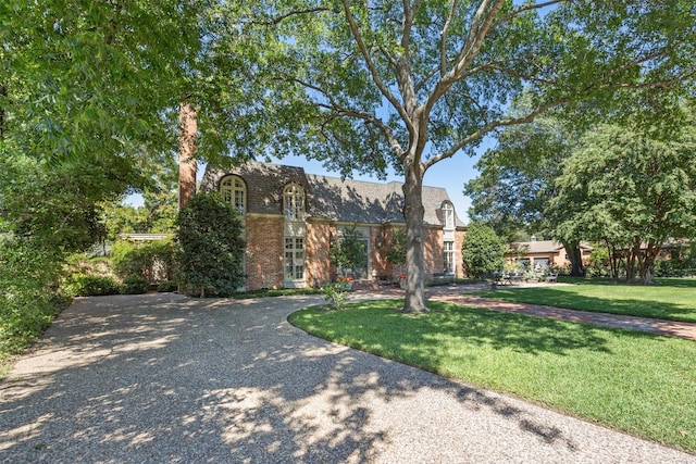 tudor home featuring a front yard