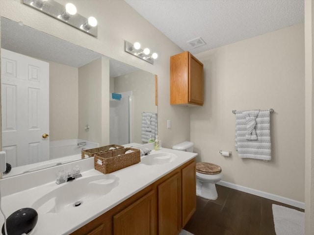 full bathroom with separate shower and tub, vanity, toilet, and a textured ceiling