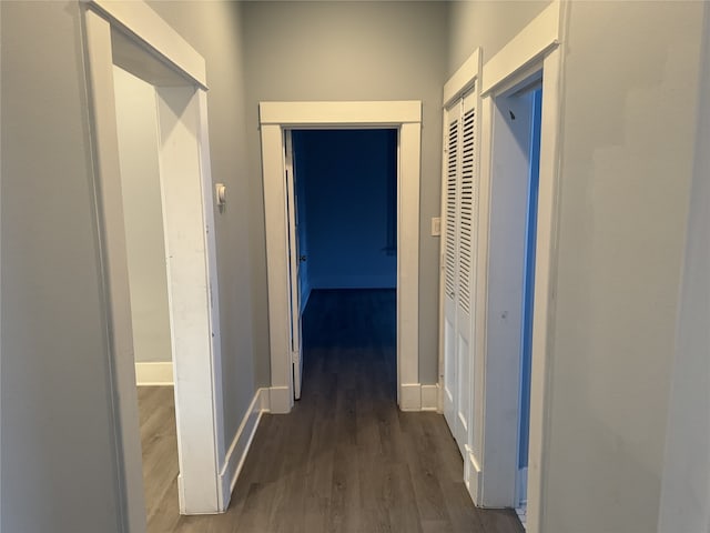 hallway with dark hardwood / wood-style flooring