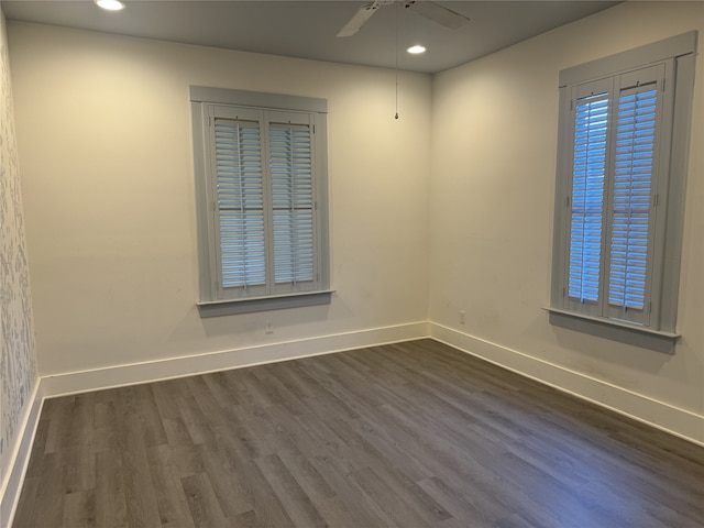 empty room featuring ceiling fan and dark hardwood / wood-style flooring