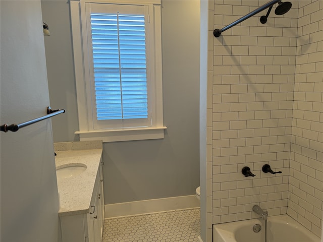 full bathroom featuring toilet, vanity, tiled shower / bath, and tile patterned flooring