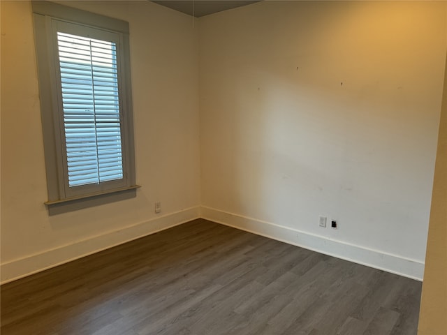 spare room with dark wood-type flooring