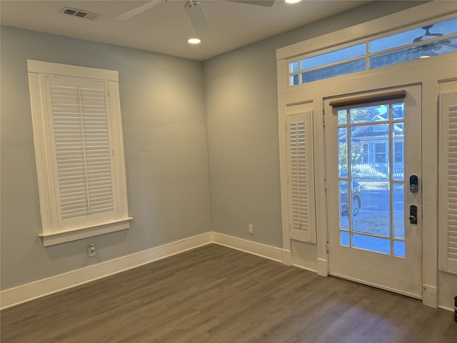 entrance foyer with ceiling fan and dark wood-type flooring