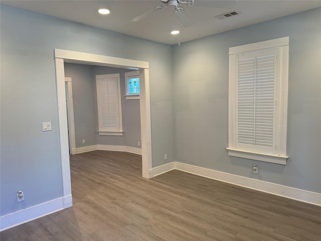 unfurnished room with ceiling fan and dark hardwood / wood-style flooring