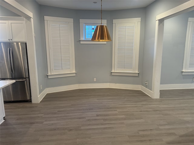 unfurnished dining area with dark hardwood / wood-style floors