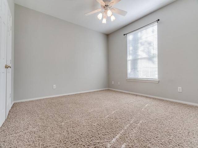 carpeted empty room featuring ceiling fan