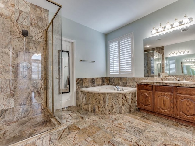 bathroom featuring a shower with shower door and vanity