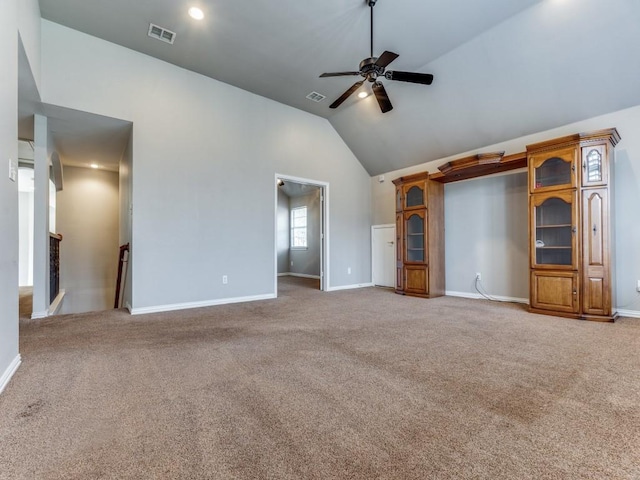 unfurnished living room with ceiling fan, high vaulted ceiling, and carpet flooring