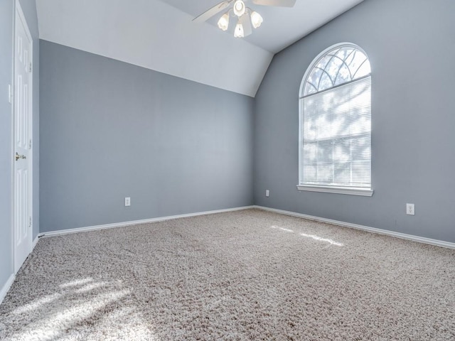 carpeted empty room featuring vaulted ceiling and ceiling fan