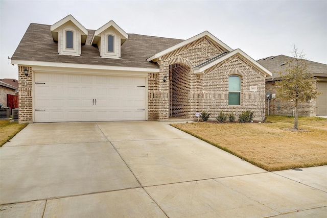 view of front of home featuring central AC and a garage