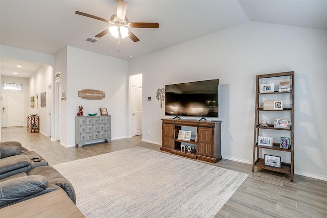 living room featuring vaulted ceiling and ceiling fan