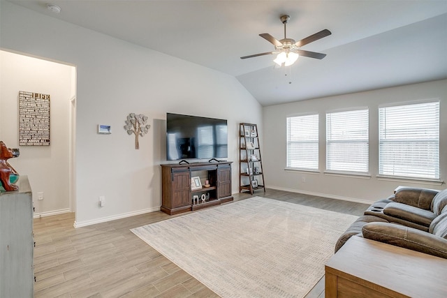 living room featuring ceiling fan, vaulted ceiling, and light wood-type flooring