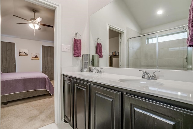 bathroom with ceiling fan, vanity, lofted ceiling, and a shower with door