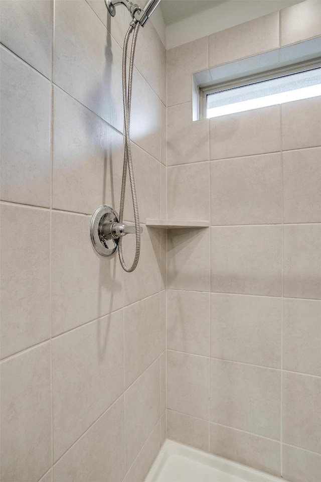 bathroom with a tile shower