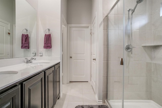 bathroom with tile patterned floors, walk in shower, and vanity