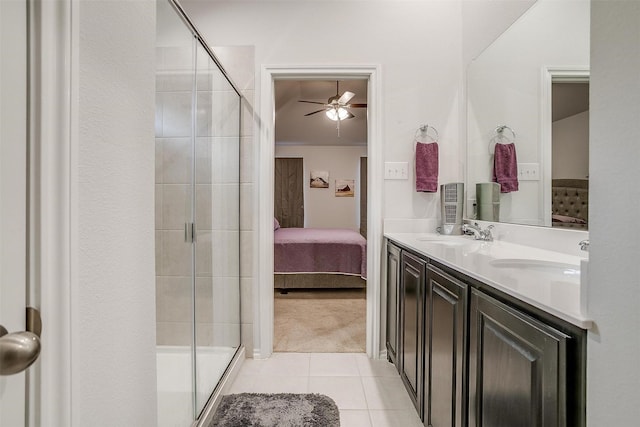 bathroom featuring ceiling fan, tile patterned flooring, a shower with door, and vanity