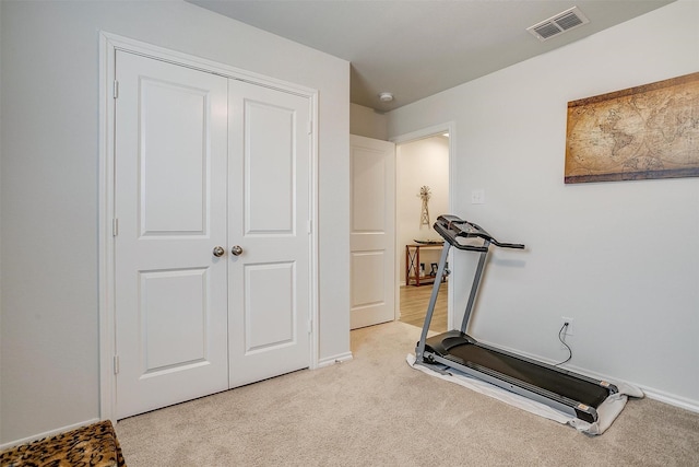 exercise room with light colored carpet