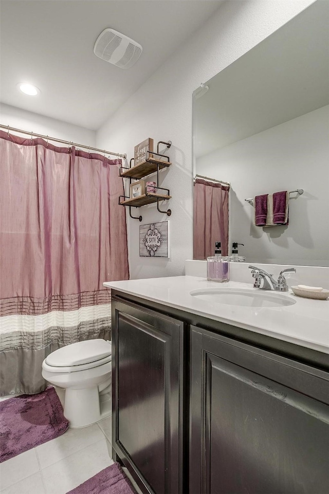 bathroom with curtained shower, toilet, vanity, and tile patterned flooring