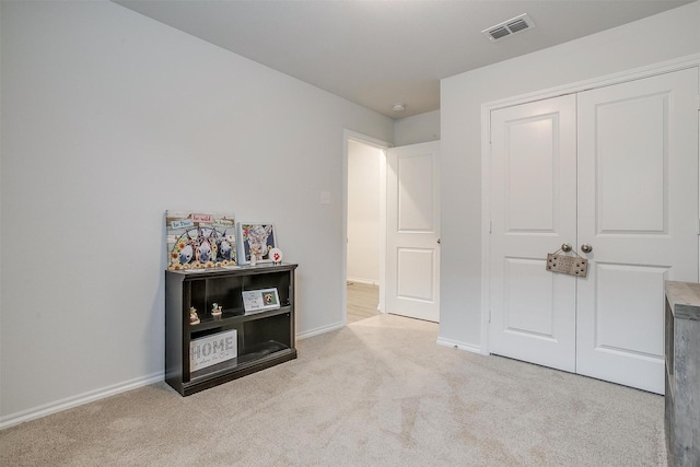 carpeted bedroom with a closet