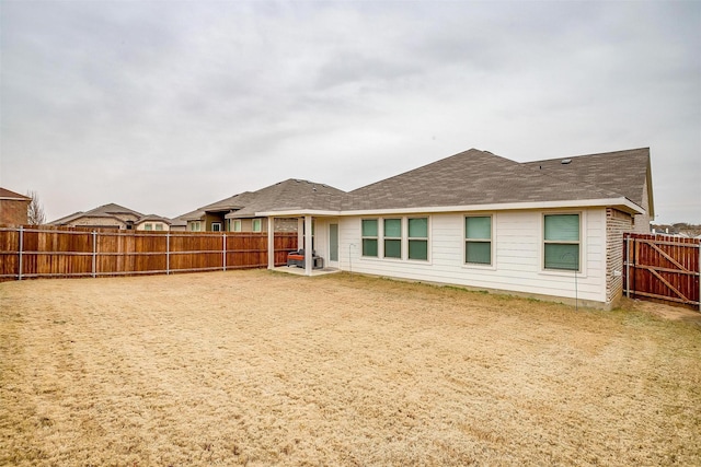 rear view of property featuring a lawn