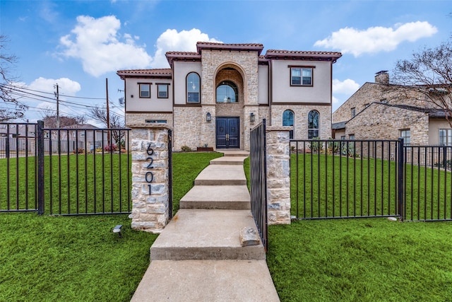 mediterranean / spanish house featuring a front yard