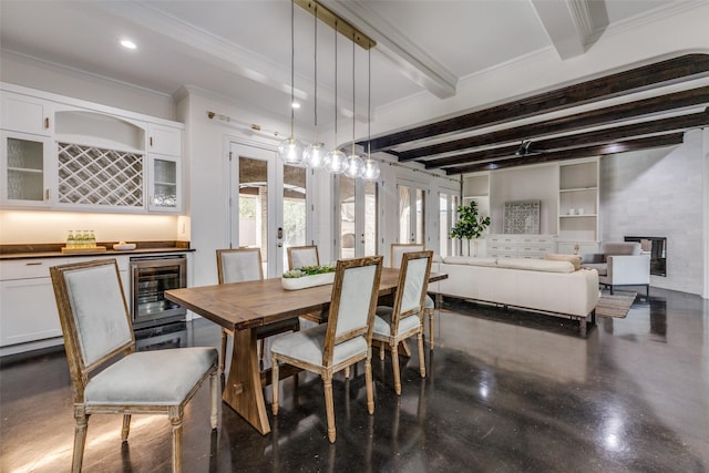 dining room featuring indoor bar, wine cooler, built in features, beam ceiling, and ornamental molding