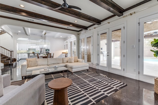 living room featuring ornamental molding, beamed ceiling, ceiling fan, and french doors