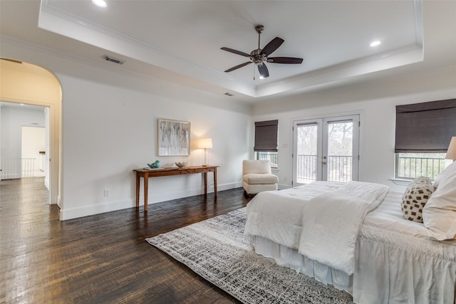 bedroom with ceiling fan, a tray ceiling, and access to outside